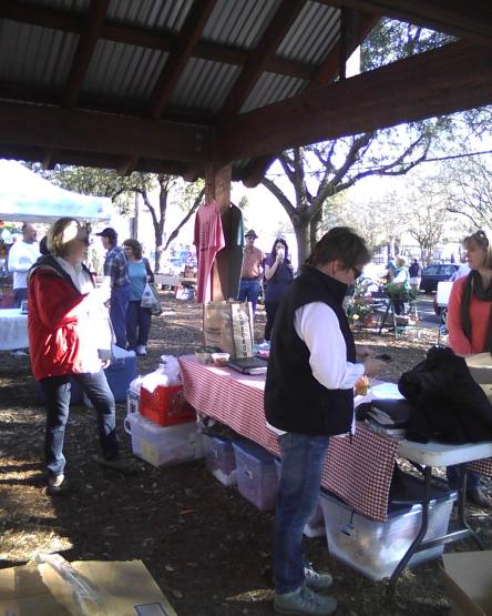 Jan in vest is the long time market manager and has a great attitude about her rural parish seat farmers market. Her sister Ann (in the red jacket) helps with logistics and announcements.